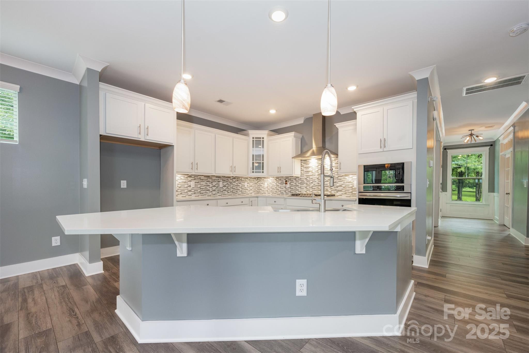 651-r L R L Stowe Road Belmont, NC 28012 - Photo 12 of 35 a large kitchen with kitchen island a stove a sink a center island and wooden floor