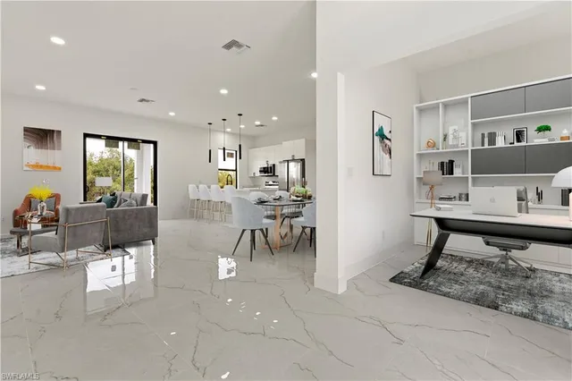a living room with furniture a dining table and kitchen view