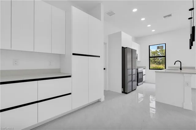 a view of a kitchen with refrigerator and cabinet