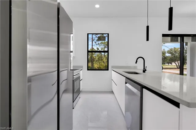 a kitchen with a sink and refrigerator