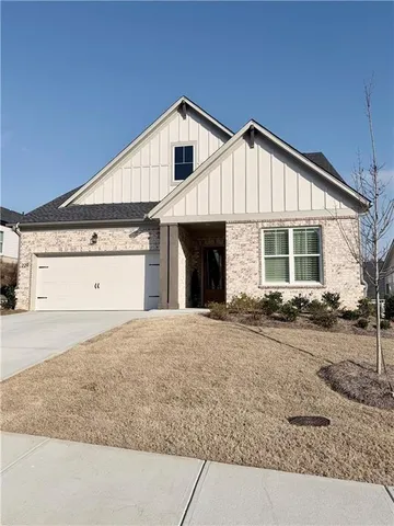 a view of a house with a yard and garage