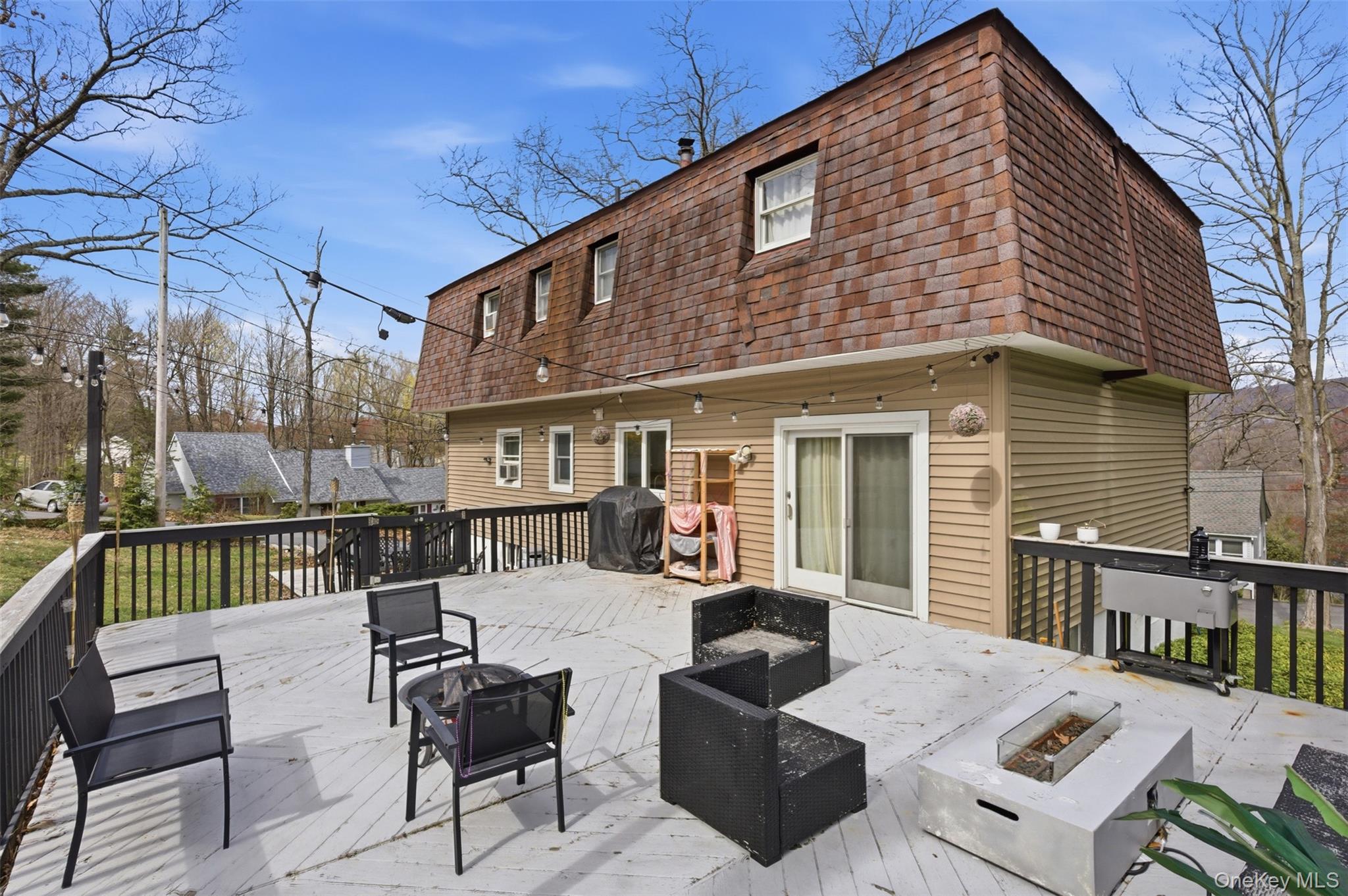 2 Olympus Road Highland Mills, NY 10930 - Photo 17 of 31 a view of a patio with couches table and chairs and wooden fence