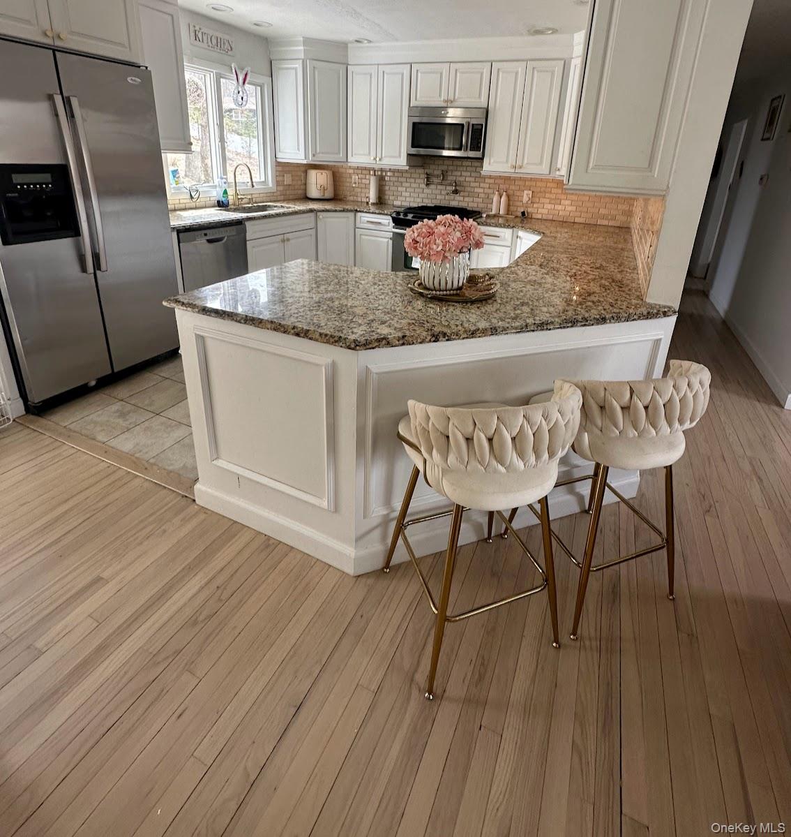 2 Olympus Road Highland Mills, NY 10930 - Photo 7 of 31 a kitchen with stainless steel appliances granite countertop a kitchen island hardwood floor sink stove dining table and chairs