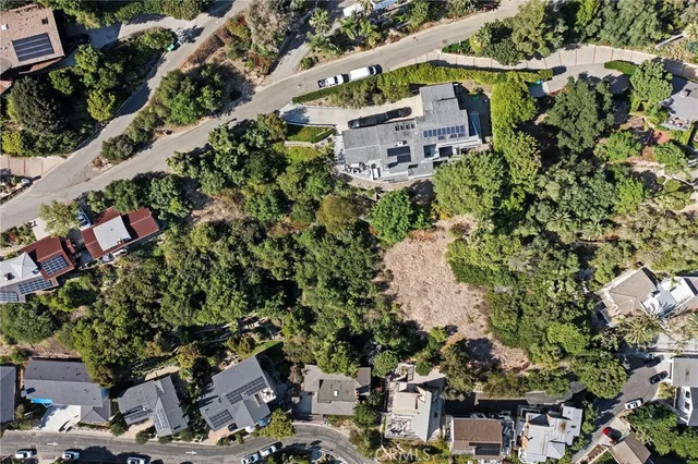 an aerial view of a house with a yard and outdoor seating