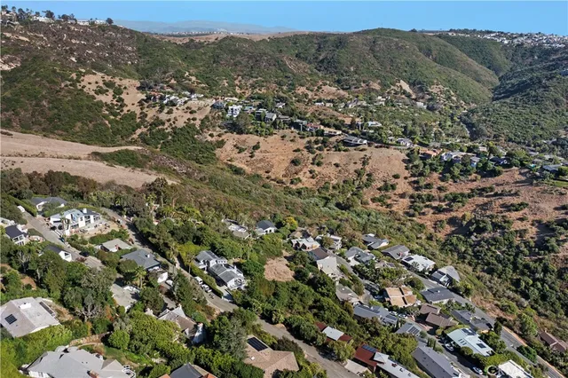 an aerial view of residential houses with city view