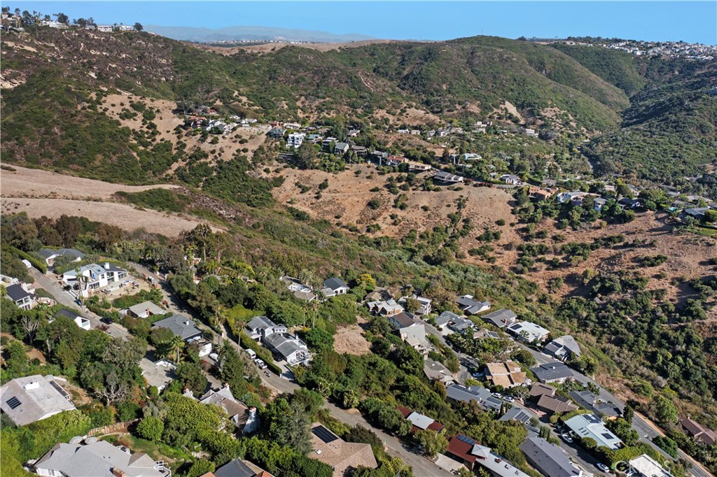 1863 Rim Rock Canyon Road Laguna Beach, CA 92651 - Photo 18 of 32 an aerial view of a houses with a lush green hillside