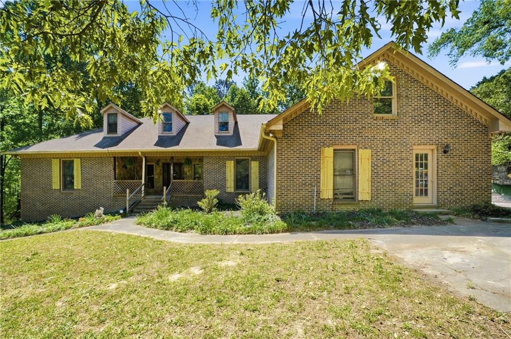 2737 John Petree Road Powder Springs, GA 30127 - Photo 1 of 55 a front view of a house with a yard