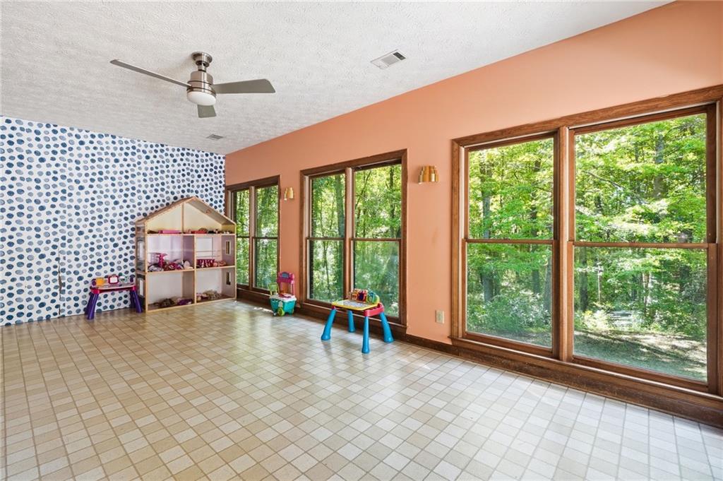 2737 John Petree Road Powder Springs, GA 30127 - Photo 20 of 55 a view of a room with wooden floor and ceiling fan