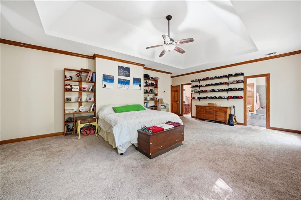 2737 John Petree Road Powder Springs, GA 30127 - Photo 24 of 55 a bedroom with a bed and a chandelier