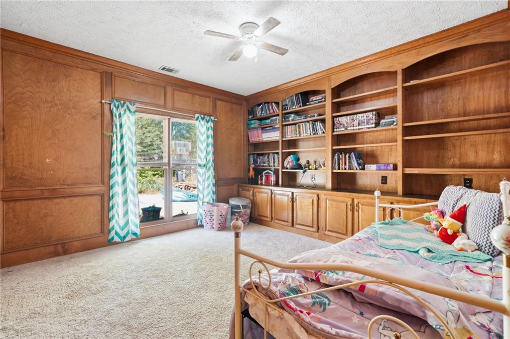 2737 John Petree Road Powder Springs, GA 30127 - Photo 29 of 55 a bedroom with furniture and a book shelf