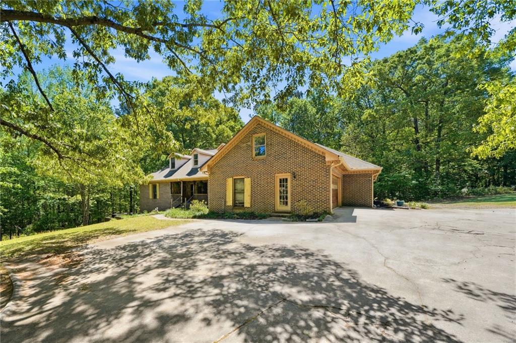 2737 John Petree Road Powder Springs, GA 30127 - Photo 3 of 55 a front view of a house with a yard