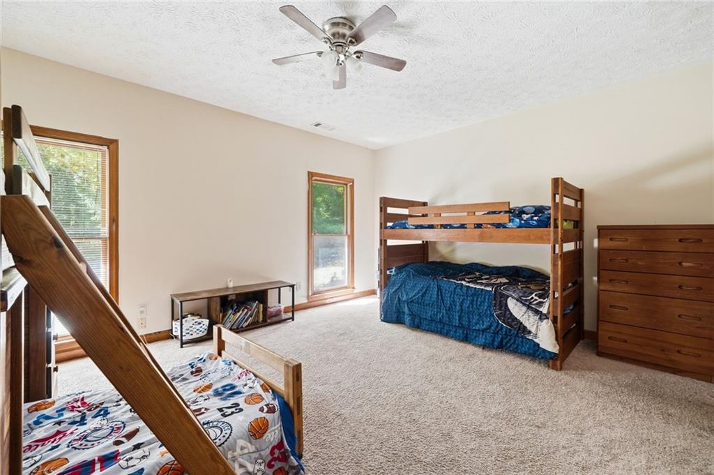 2737 John Petree Road Powder Springs, GA 30127 - Photo 31 of 55 a bedroom with a bed and wooden floor