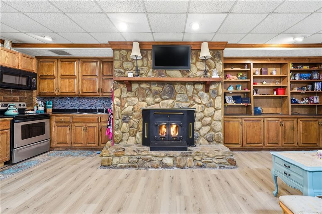 2737 John Petree Road Powder Springs, GA 30127 - Photo 32 of 55 a living room with stainless steel appliances furniture a fireplace a flat screen tv and a fireplace