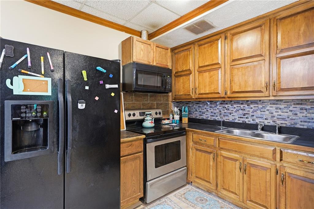 2737 John Petree Road Powder Springs, GA 30127 - Photo 34 of 55 a kitchen with stainless steel appliances granite countertop a stove and a refrigerator