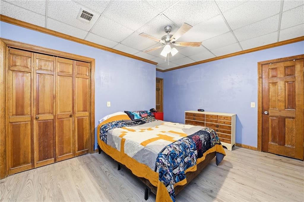 2737 John Petree Road Powder Springs, GA 30127 - Photo 43 of 55 a bedroom with a bed and wooden floor