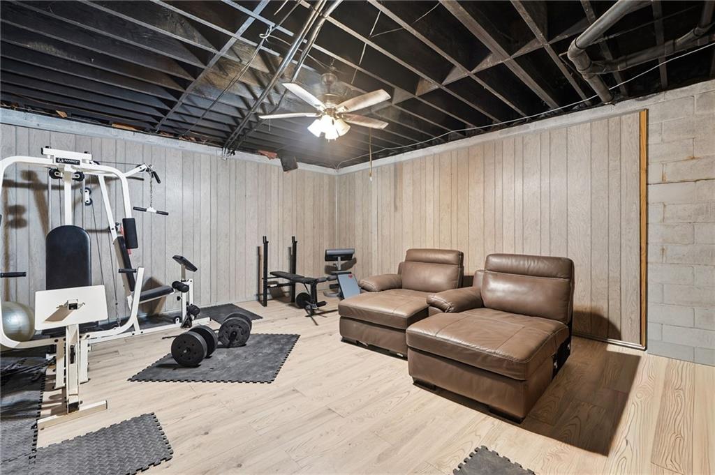 2737 John Petree Road Powder Springs, GA 30127 - Photo 45 of 55 a living room with furniture a flat screen tv and gym equipment
