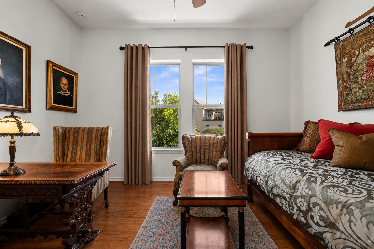 204 Adams Street Georgetown, TX 78628 - Photo 24 of 33 An inviting secondary bedroom featuring rich hardwood flooring and sun-filled windows with outdoor views.