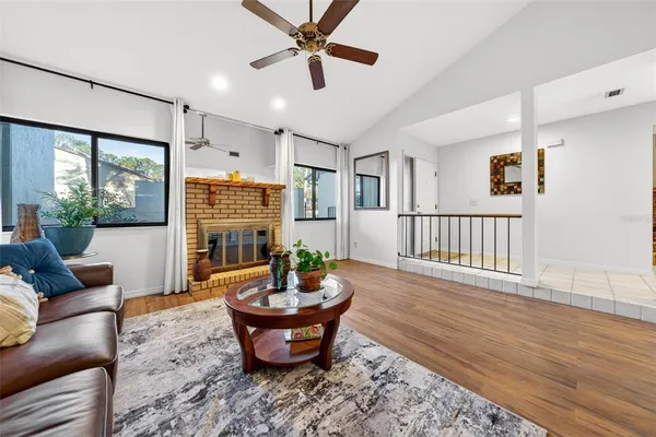 a living room with furniture and a wooden floor