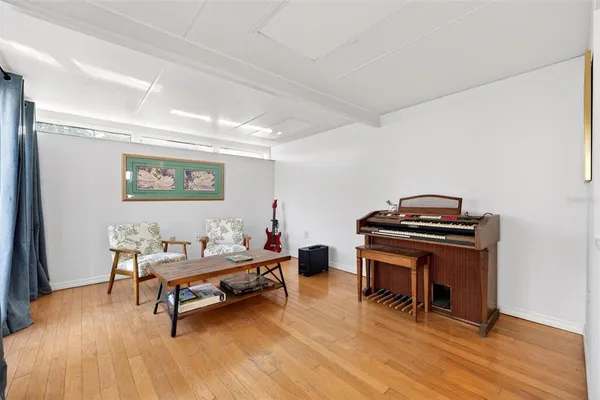 a view of a workspace with furniture and wooden floor