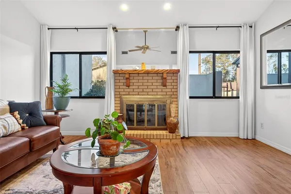 a living room with furniture and a fireplace