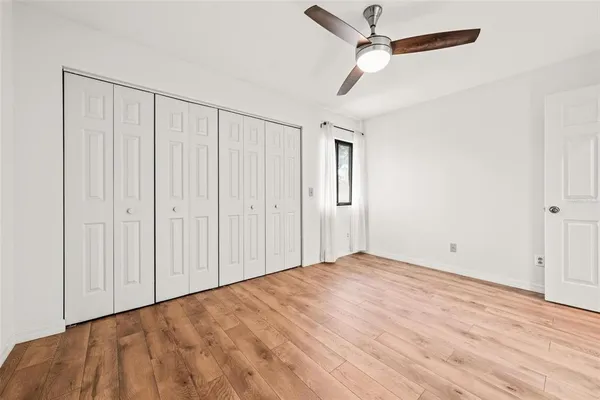 a view of a small yard with wooden floor and fence
