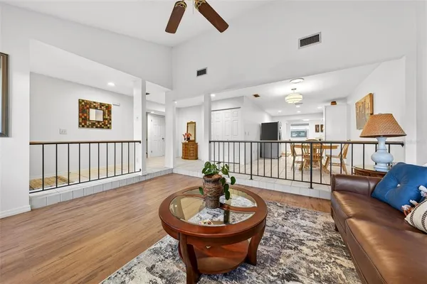 a living room with furniture a rug and a chandelier