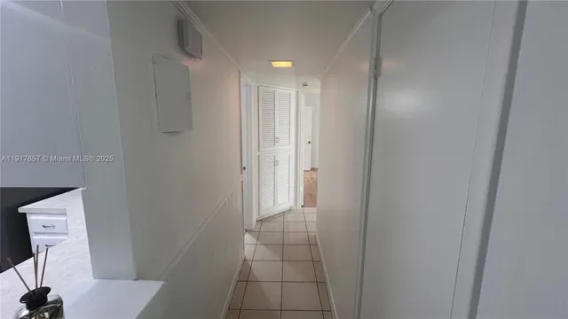 an empty room with wooden floor and ceiling fan