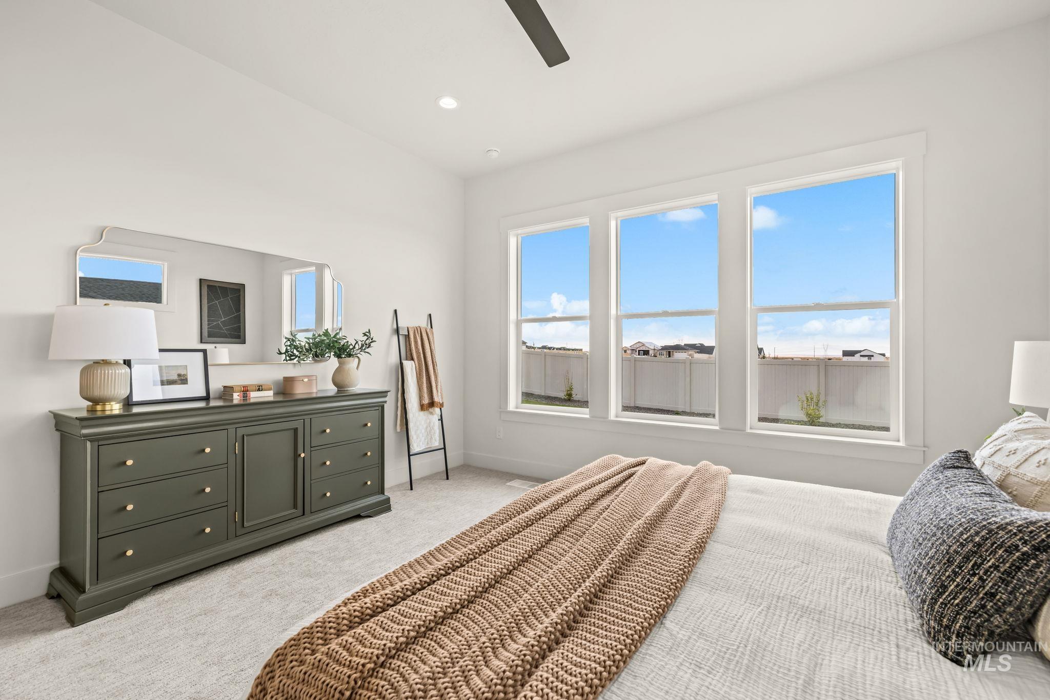 345 South Strut Way Boise, ID 83716 - Photo 25 of 50 Triple windows, white walls, recessed lighting, ceiling fan, and carpeted flooring