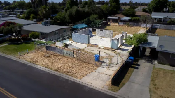 an aerial view of a house with garden space and lake view