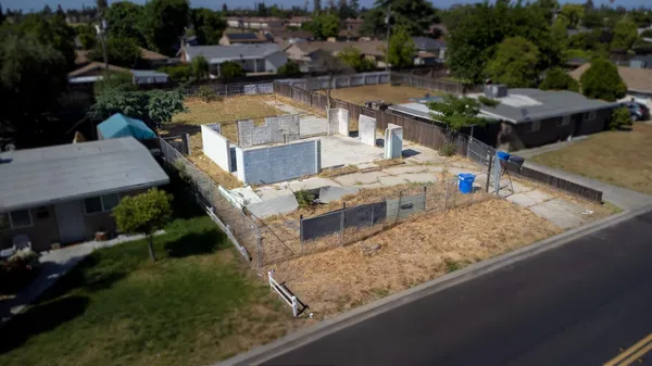 a view of a house with pool and chairs