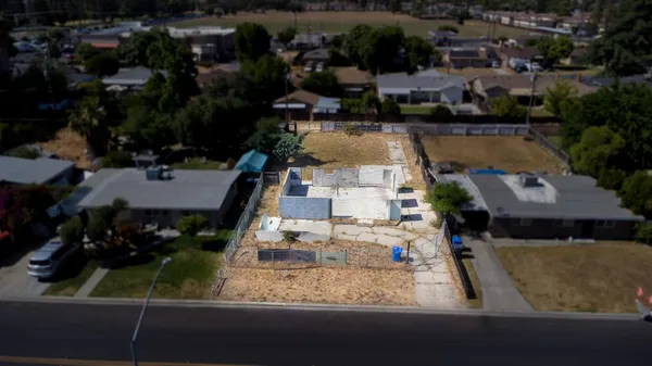 an aerial view of residential houses with outdoor space