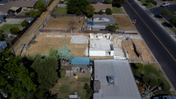 an aerial view of a house with a yard