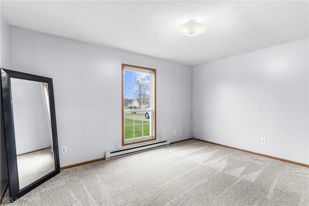 4075 Kirk Road Austintown, OH 44511 - Photo 16 of 40 Empty room with carpet, baseboard heating, and baseboards