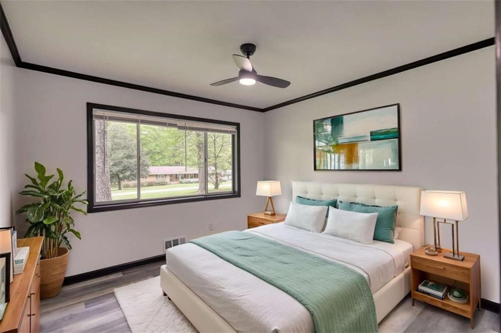 555 Joy Street Jackson, GA 30233 - Photo 28 of 56 a bedroom with a bed and a potted plant