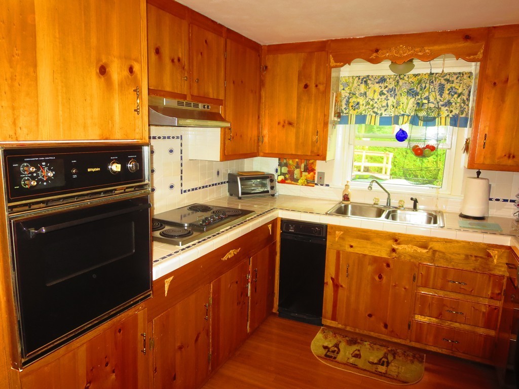 45 Hadley Street Springfield, MA 01118 - Photo 11 of 21 a kitchen with stainless steel appliances granite countertop a stove a sink and a microwave