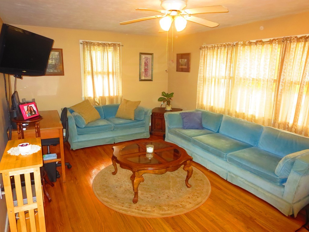 45 Hadley Street Springfield, MA 01118 - Photo 2 of 21 a living room with furniture and a flat screen tv