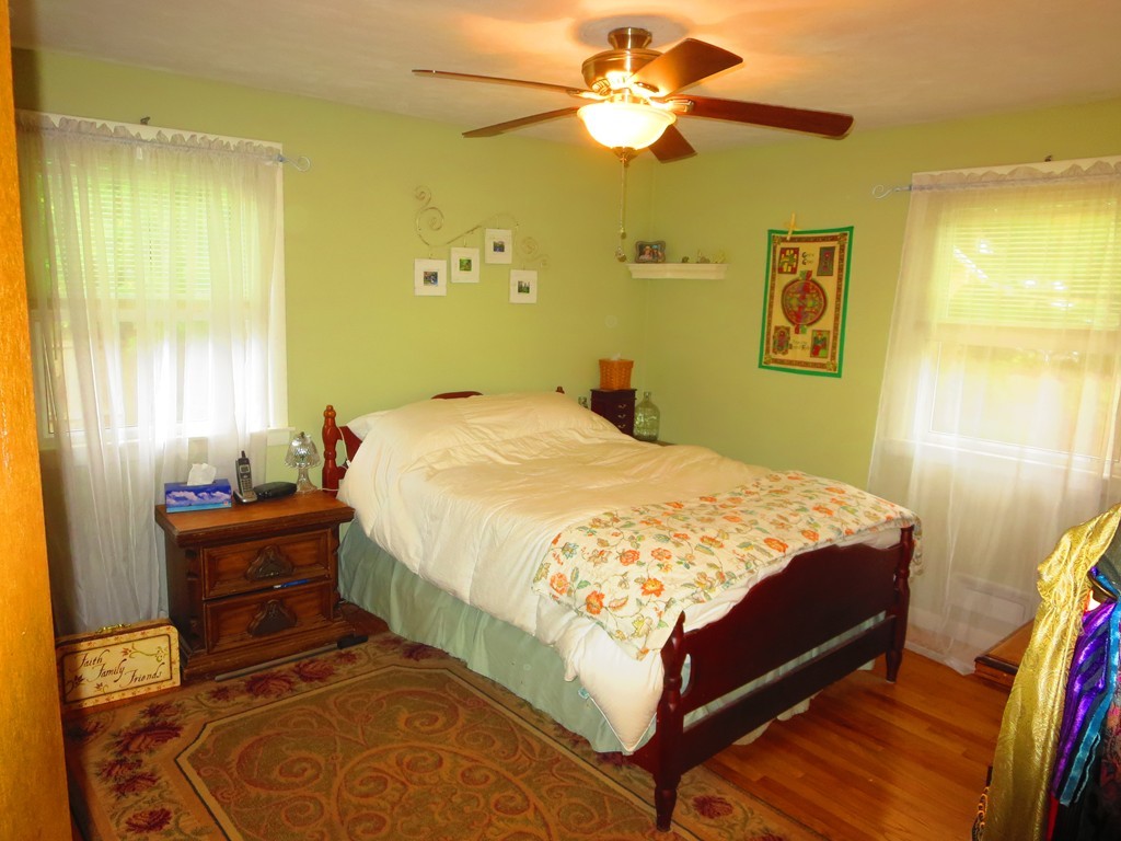 45 Hadley Street Springfield, MA 01118 - Photo 5 of 21 a bedroom with a bed and wooden floor