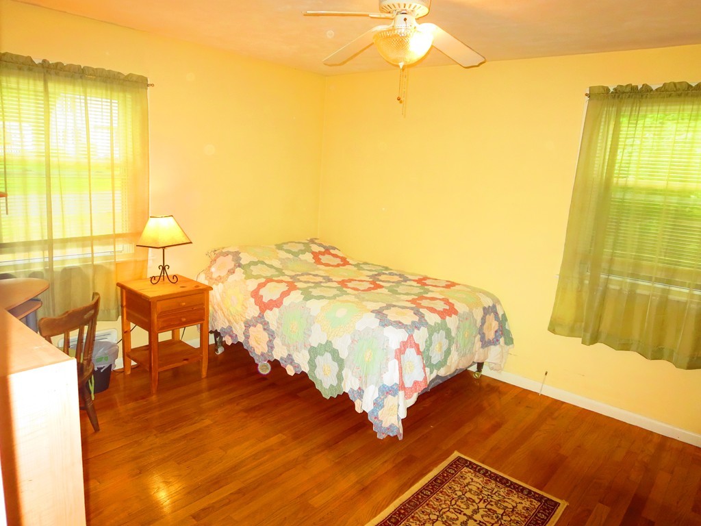 45 Hadley Street Springfield, MA 01118 - Photo 6 of 21 a bedroom with a bed and wooden floor