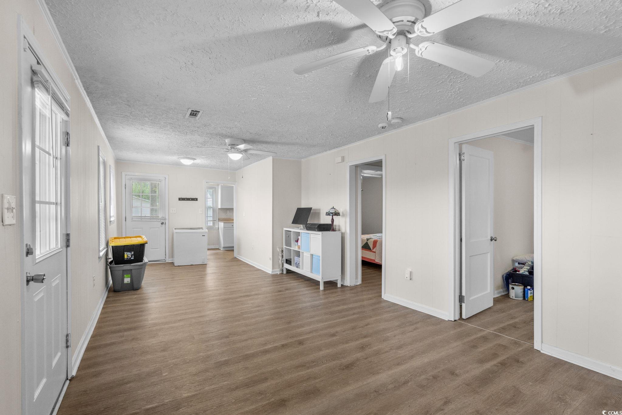 2475 Beverly Road Conway, SC 29527 - Photo 12 of 34 Living room featuring wood finished floors, a textured ceiling, and ceiling fan