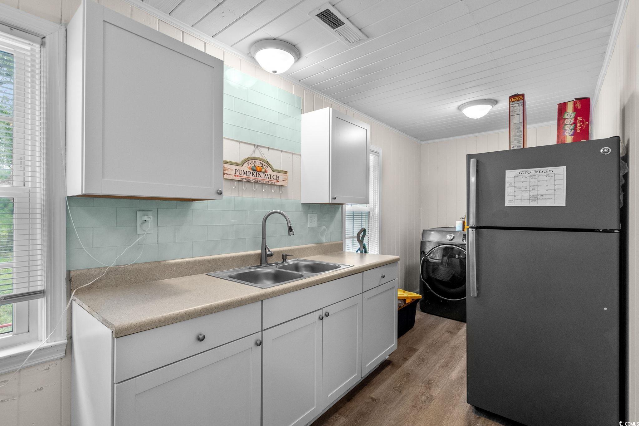 2475 Beverly Road Conway, SC 29527 - Photo 16 of 34 Kitchen featuring freestanding refrigerator, healthy amount of natural light, dark wood finished floors, and washer / dryer