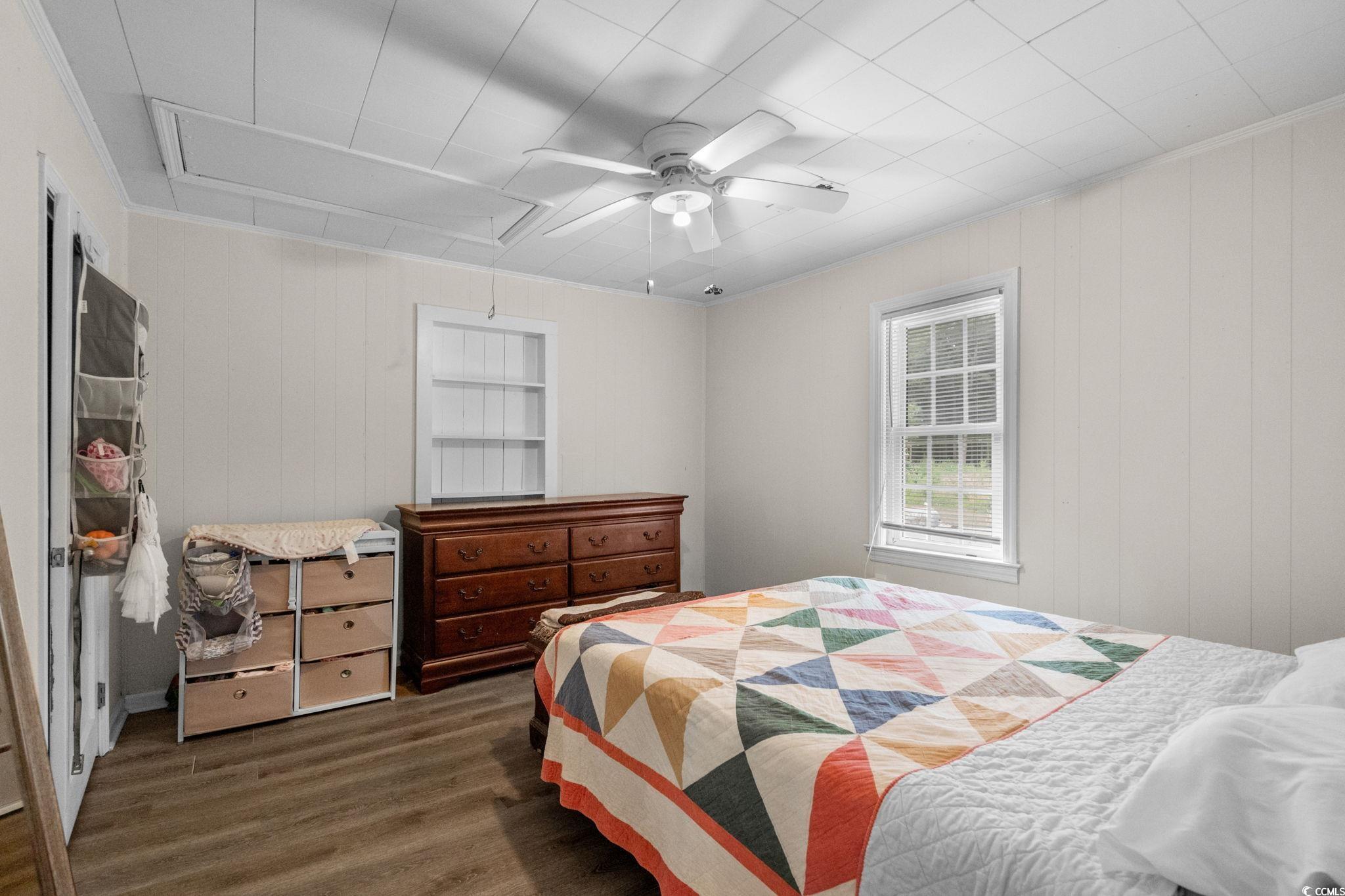 2475 Beverly Road Conway, SC 29527 - Photo 17 of 34 Bedroom with wood finished floors, ceiling fan, attic access, wooden walls, and ornamental molding
