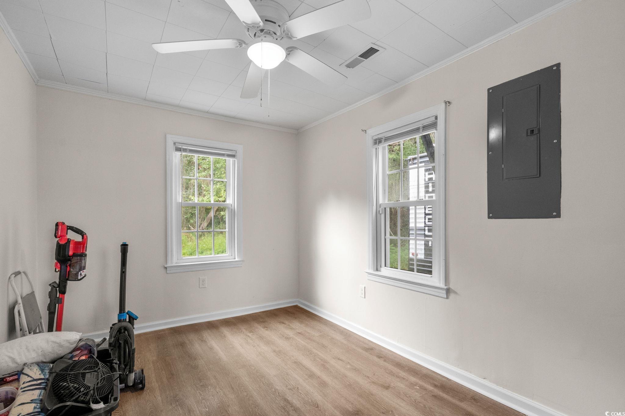 2475 Beverly Road Conway, SC 29527 - Photo 19 of 34 Exercise area featuring crown molding, electric panel, light wood finished floors, and a ceiling fan
