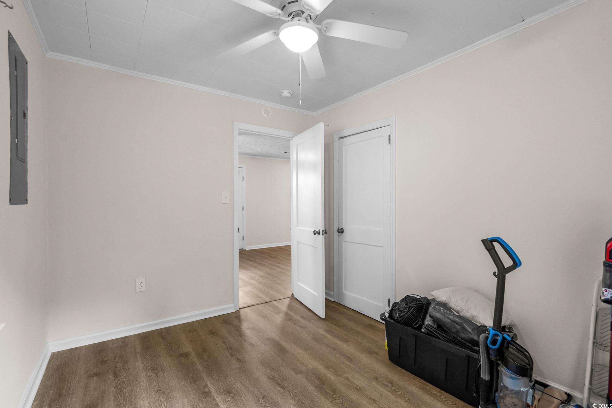 2475 Beverly Road Conway, SC 29527 - Photo 20 of 34 Exercise area featuring crown molding, wood finished floors, ceiling fan, and electric panel