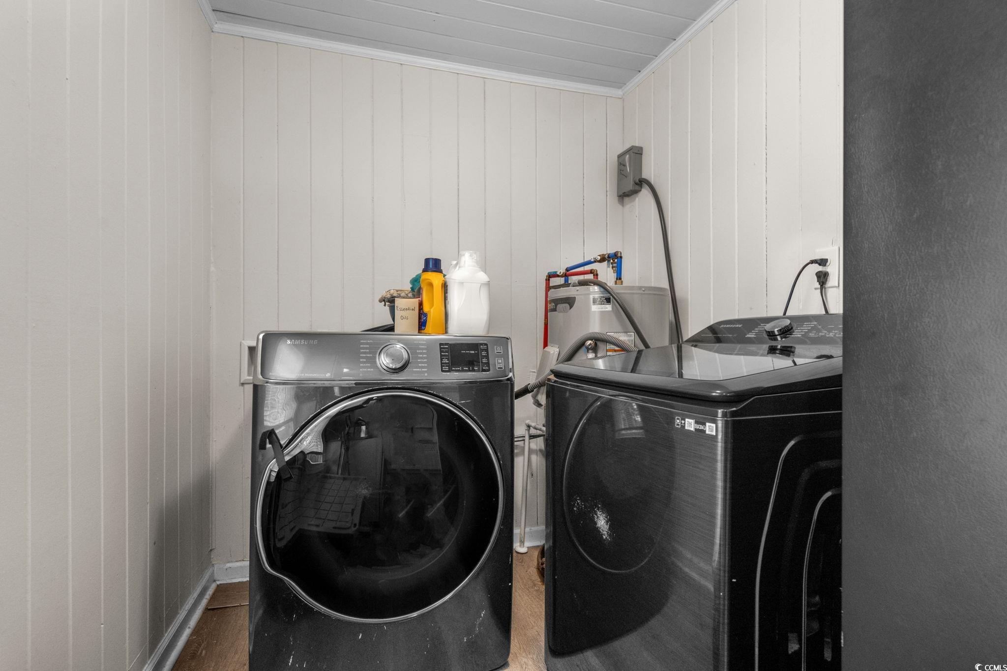 2475 Beverly Road Conway, SC 29527 - Photo 22 of 34 Washroom featuring washing machine and clothes dryer, wooden walls, water heater, wood finished floors, and crown molding