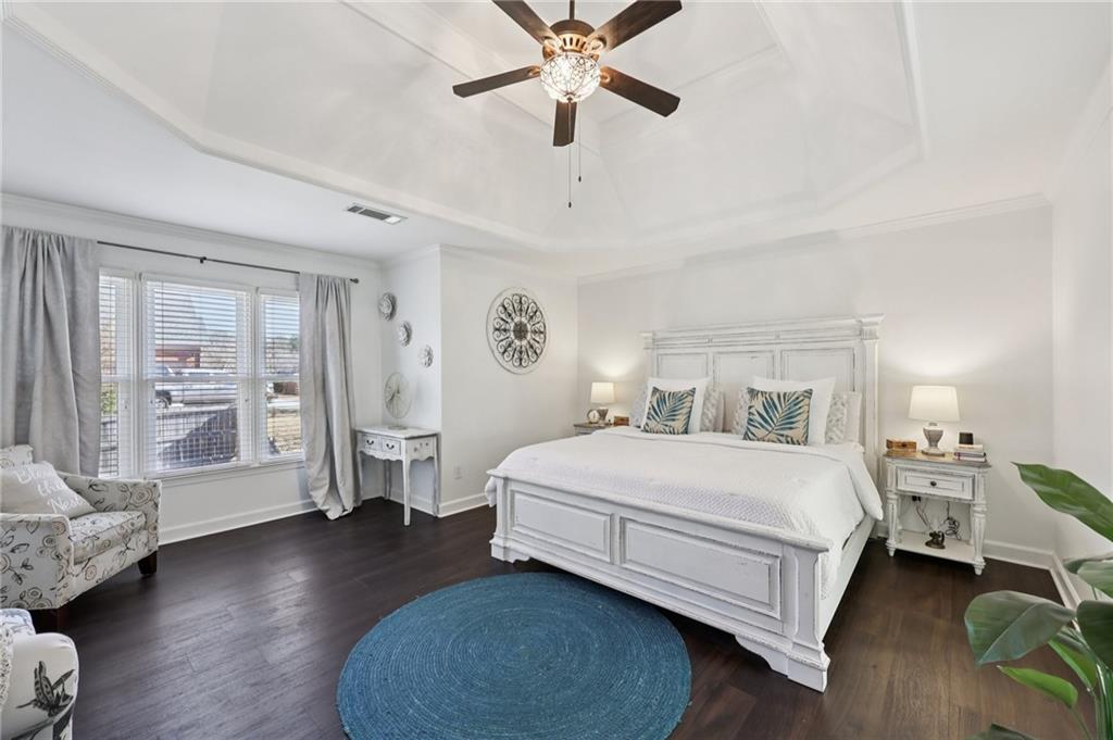 704 Highland Ridge Pointe Lawrenceville, GA 30045 - Photo 16 of 36 a bedroom with a bed chandelier and a window