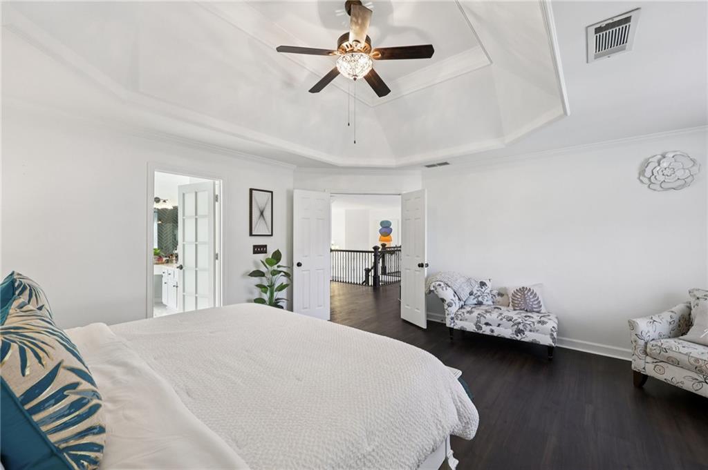 704 Highland Ridge Pointe Lawrenceville, GA 30045 - Photo 17 of 36 a bedroom with bed and a chandelier