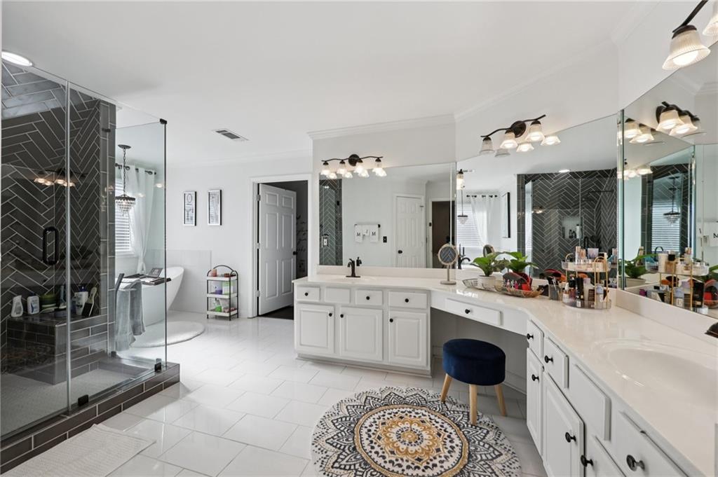 704 Highland Ridge Pointe Lawrenceville, GA 30045 - Photo 18 of 36 a large white kitchen with a stove a sink dishwasher and a refrigerator with wooden floor