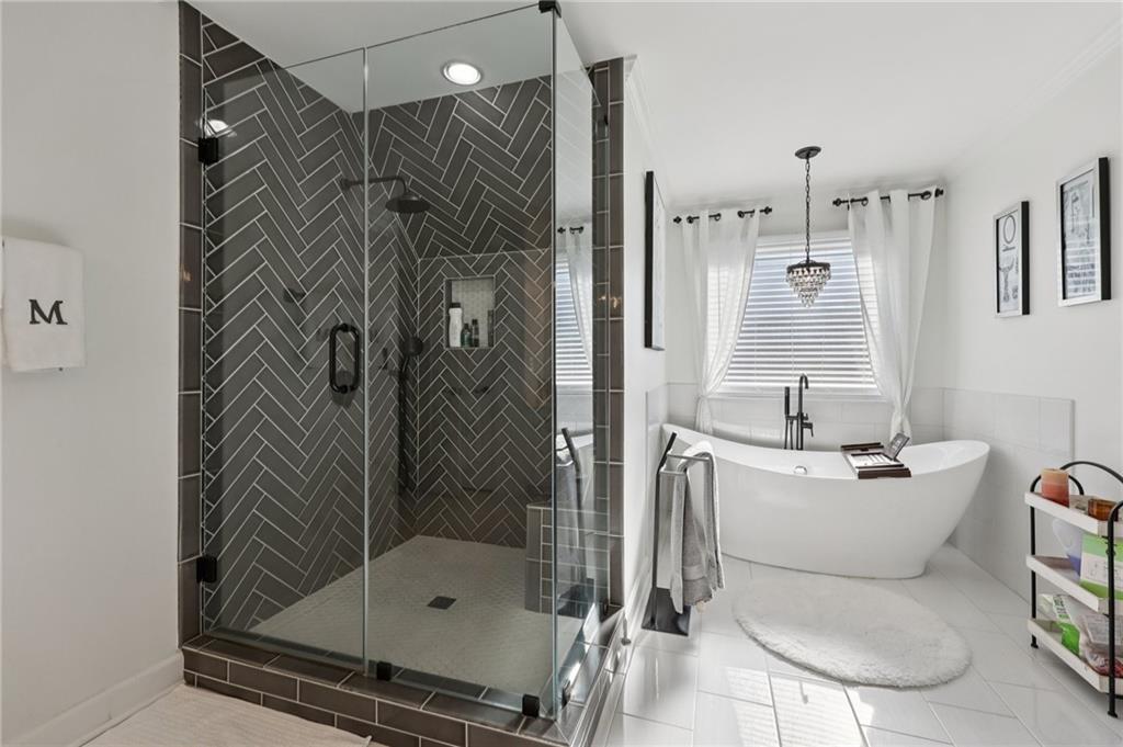 704 Highland Ridge Pointe Lawrenceville, GA 30045 - Photo 19 of 36 a bathroom with a shower a toilet and sink