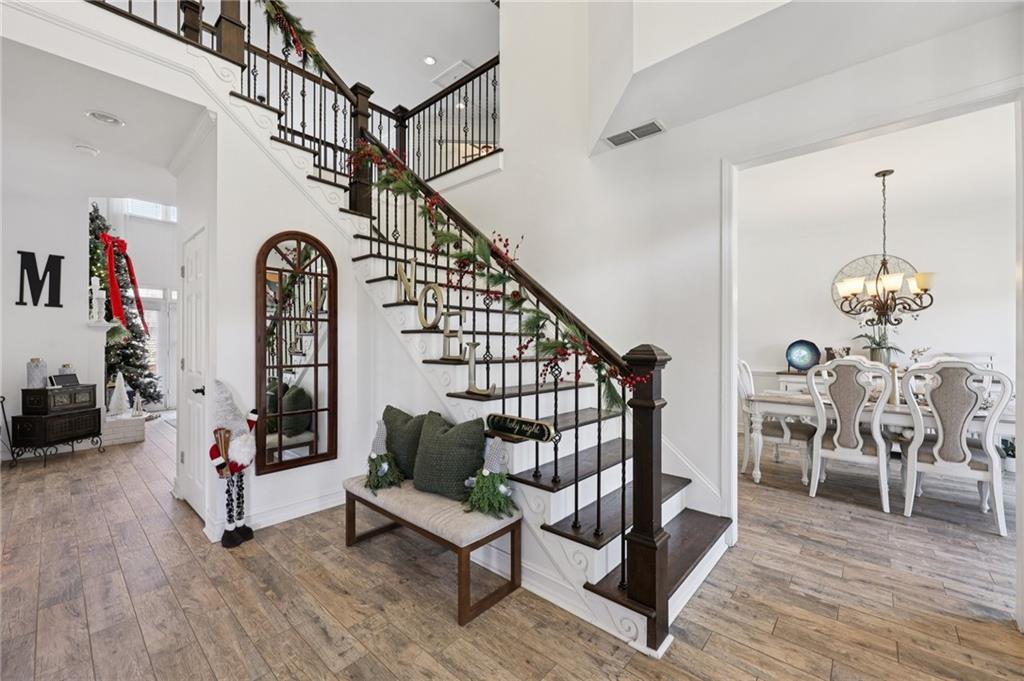 704 Highland Ridge Pointe Lawrenceville, GA 30045 - Photo 2 of 36 a living room with fireplace furniture and a wooden floor