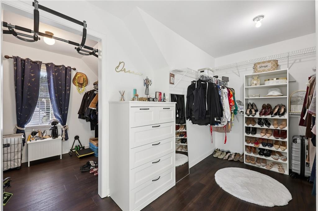 704 Highland Ridge Pointe Lawrenceville, GA 30045 - Photo 21 of 36 a view of walk in closet with clothes and shoes